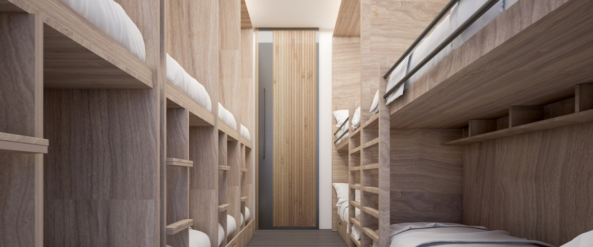 Een lege kamer in een jeugdherberg met modern stapelbedden langs beide kanten van de muur